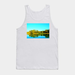 Scene from Lago Cedri in Lapedona with trees bathed in sunlight and the calm waters of the lake reflecting that lushness Tank Top